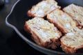 Frying scrapple slices on a cast iron pan Royalty Free Stock Photo