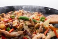 Frying vegetables and meat in hot cast iron skillet Royalty Free Stock Photo