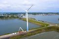 Enormous windmills stand in the sea along a dutch sea. FryslÃÂ¢n wind farm, the largest inland wind farm in the world.