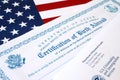 Fs-545 Certification of birth abroad lies on United States flag with envelope from Department of Homeland Security Royalty Free Stock Photo