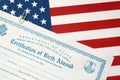 Fs-545 Certification of birth abroad lies on United States flag from US Foreign service Royalty Free Stock Photo