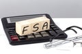 FSA concept on wooden cubes on calculator on white background Royalty Free Stock Photo