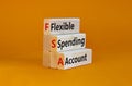FSA flexible spending account symbol. Concept words FSA flexible spending account on wooden blocks on a beautiful orange