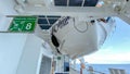 An empty deck with a life boat above of a cruise ship sailing on the Atlantic ocean