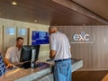 A male passenger inquiring and purchasing shore excursions from the crew of a Holland America Line cruise ship