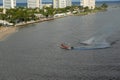 A US Coast Guard boat escorts a cruise ship into or out of port from the ocean channel