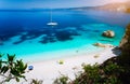 Fteri beach, Cephalonia Kefalonia, Greece. White catamaran yacht in clear blue sea water. Tourists on sandy beach near Royalty Free Stock Photo