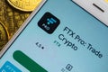 The FTX cryptocurrency exchange apps on a smartphone screen, which is lying on bitcoin coins. The concept of FTX Royalty Free Stock Photo