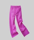 Fuchsia color jeans isolated on gtey. Pink womens fashion pants