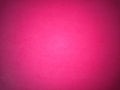 Fuchsia color paper background. Dark light vignetting around the edges. Background, greeting card or declaration of love