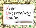 FUD fear uncertainty doubt symbol. Concept words FUD fear uncertainty doubt on white note on a beautiful background from dollar Royalty Free Stock Photo