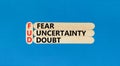 FUD fear uncertainty doubt symbol. Concept words FUD fear uncertainty doubt on wooden sticks on a beautiful blue table blue Royalty Free Stock Photo