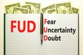 FUD fear uncertainty doubt symbol. Concept words FUD fear uncertainty doubt on white note on a beautiful background from dollar Royalty Free Stock Photo