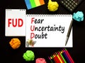 FUD fear uncertainty doubt symbol. Concept words FUD fear uncertainty doubt on white note on a beautiful black background. Royalty Free Stock Photo