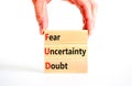 FUD fear uncertainty doubt symbol. Concept words FUD fear uncertainty doubt on wooden blocks on a beautiful white table white Royalty Free Stock Photo