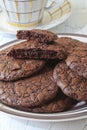 Fudge brownie cookies on crockery plate and cup Royalty Free Stock Photo