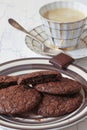 Fudge brownie cookies on crockery plate and cup of coffee Royalty Free Stock Photo