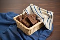 fudgy brownies in a basket lined with cloth