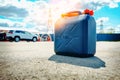 Fuel can is on the ground near a gas station. Fuel reserve in jerrycan. Royalty Free Stock Photo