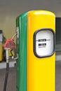 Fuel dispenser yellow and green vintage gasoline with red handle Royalty Free Stock Photo