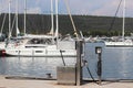 Fuel distributor on the pier of a gas station in the Mediterranean marina against the backdrop of sailing yachts. Refualing boats Royalty Free Stock Photo