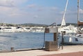 Fuel distributor on the pier of a gas station in the Mediterranean marina against the backdrop of sailing yachts. Refualing boats Royalty Free Stock Photo
