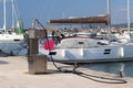 Fuel distributor on the pier of a gas station in the Mediterranean marina against the backdrop of sailing yachts. Refualing boats Royalty Free Stock Photo