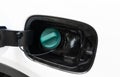 Fuel filler flap open with green diesel cap. Fuel tank cap of a car for filling. Car fuel tank hatch Royalty Free Stock Photo