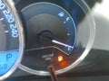 Fuel gauge showing empty tank with yellow glowing and lit meter Royalty Free Stock Photo