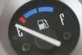 Fuel gauge with warning indicating low fuel tank.