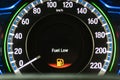 Fuel Low warning on gauge with red light icon alert sign showing oil almost empty and cars or automobile vehicle need energy Royalty Free Stock Photo