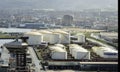 Fuel and Oil Tanks in the Petrochemical Industry in daylight. City of Gijon at background