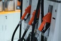 Fuel pump. Detail of a Orange hand holding a fuel pump at a station