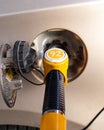 Fuel pump inserted in the gas tank hatch. Refueling a passenger car with gasoline. Yellow fuel pump with number 92 petrol , Royalty Free Stock Photo