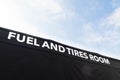 Fuel and tires area in motor sport paddock low angle view of banner text