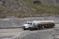 Fuel truck on dangerous gravel mountain road transporting diesel fuel to Kumtor gold mine. Industry freight truck transportation