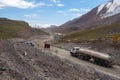 Fuel truck on dangerous gravel mountain road transporting diesel fuel to Kumtor gold mine. Industry freight truck transportation