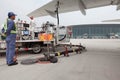 Fuel truck and fuel truck driver refueling an airplane on apron of Tianjin Binhai International Airport