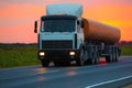 fuel truck goes on highway on sunset Royalty Free Stock Photo