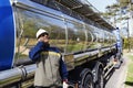 Fuel truck and refinery worker in hardhat