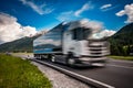 Fuel truck rushes down the highway in the background the Alps. Truck Car in motion blur Royalty Free Stock Photo