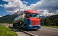 Fuel truck rushes down the highway in the background the Alps. Truck Car in motion blur Royalty Free Stock Photo