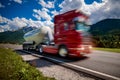 Fuel truck rushes down the highway in the background the Alps. T Royalty Free Stock Photo