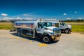 Fuel trucks parked in front of aircraft at