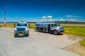 Fuel trucks parked in front of aircraft at