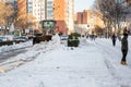 Excavator removing the large amount of snow from the road after the storm `Filomena`