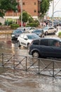 Traffic jam in a roundabout flooded by pouring rain