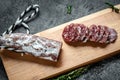Fuet Catalan dry cured sausage cut in slices. Traditional Spanish Fuet thin dried sausage Royalty Free Stock Photo