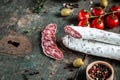 Fuet, Salami and Rosemary on wooden board closeup. Traditional Spanish sausage. place for text, top view Royalty Free Stock Photo