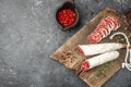 Fuet, traditional spanish dry cured sausage on a wooden board. banner, menu, recipe place for text, top view Royalty Free Stock Photo